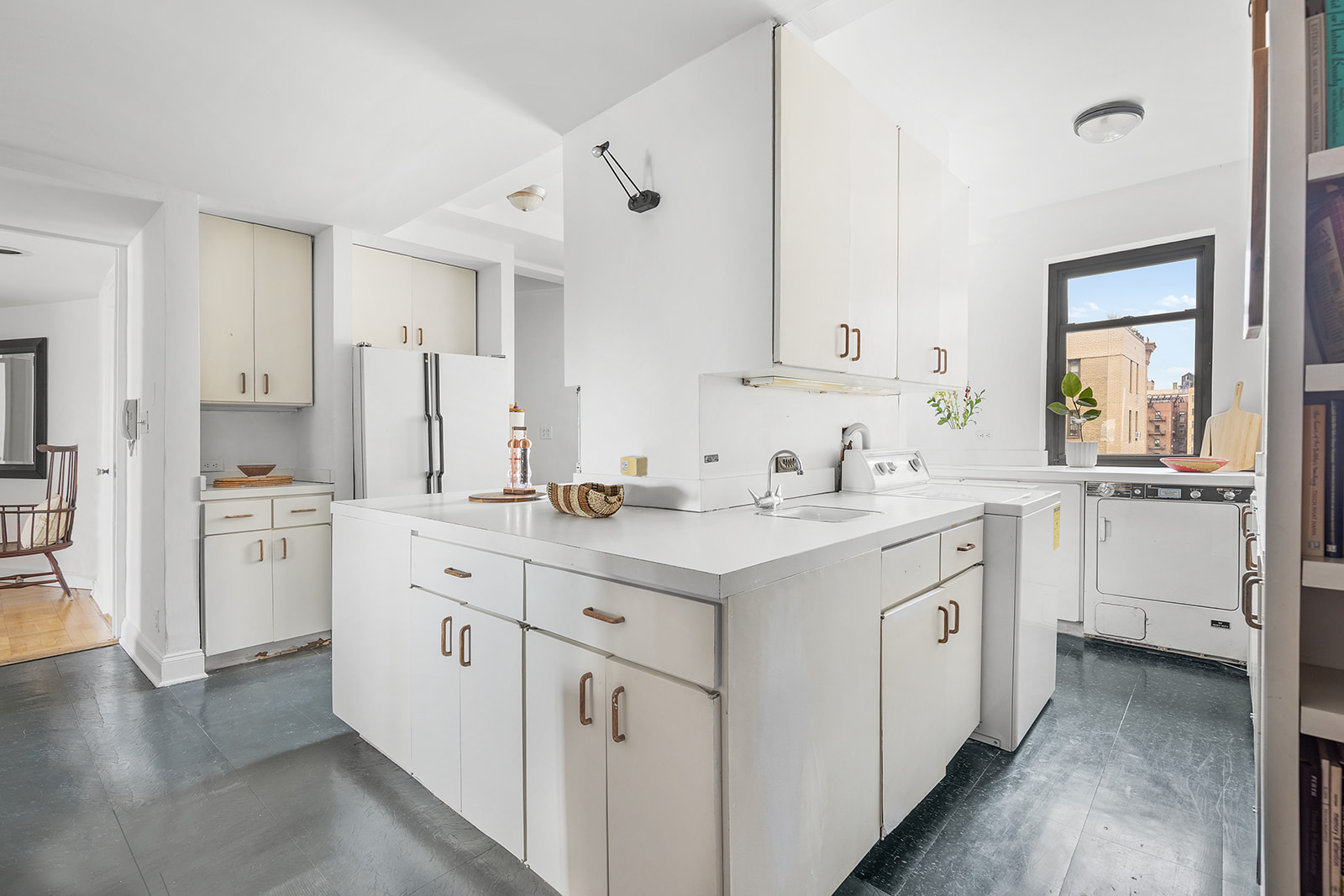 110-118 Riverside Drive, Unit 15A Manhattan, NY 10024 - Photo 4 of 17 a kitchen with white cabinets sink and white appliances