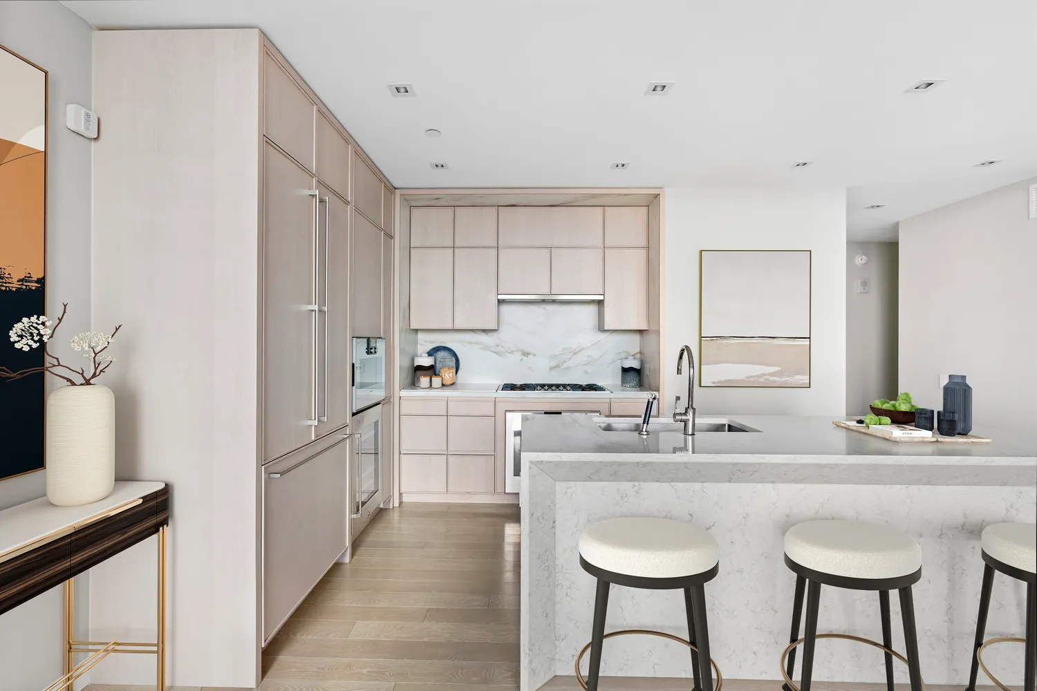 a kitchen with stainless steel appliances a sink stove and white cabinets with wooden floor