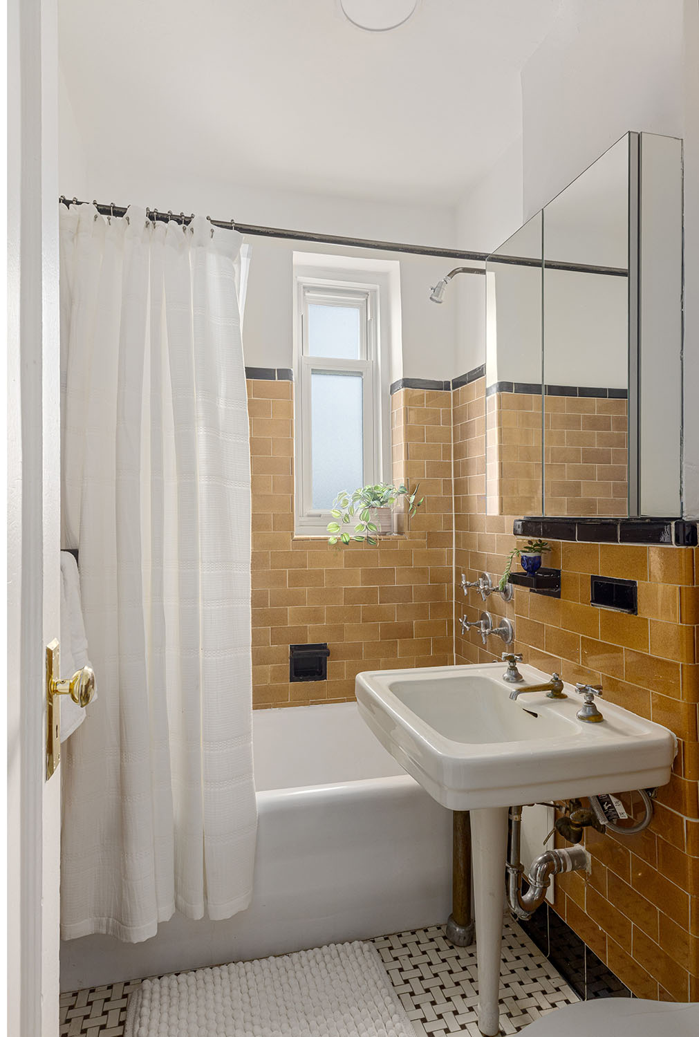 233 West 99th Street, Unit 19A Manhattan, NY 10025 - Photo 8 of 10 a bathroom with a sink a mirror and a shower