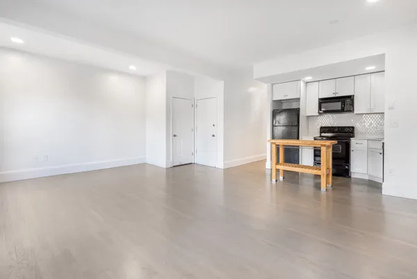 a view of kitchen with furniture and wooden floor