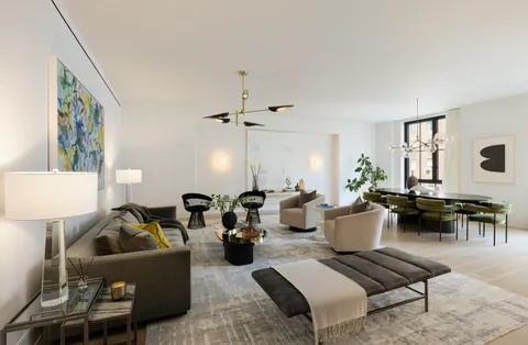 a living room with furniture and a lamp