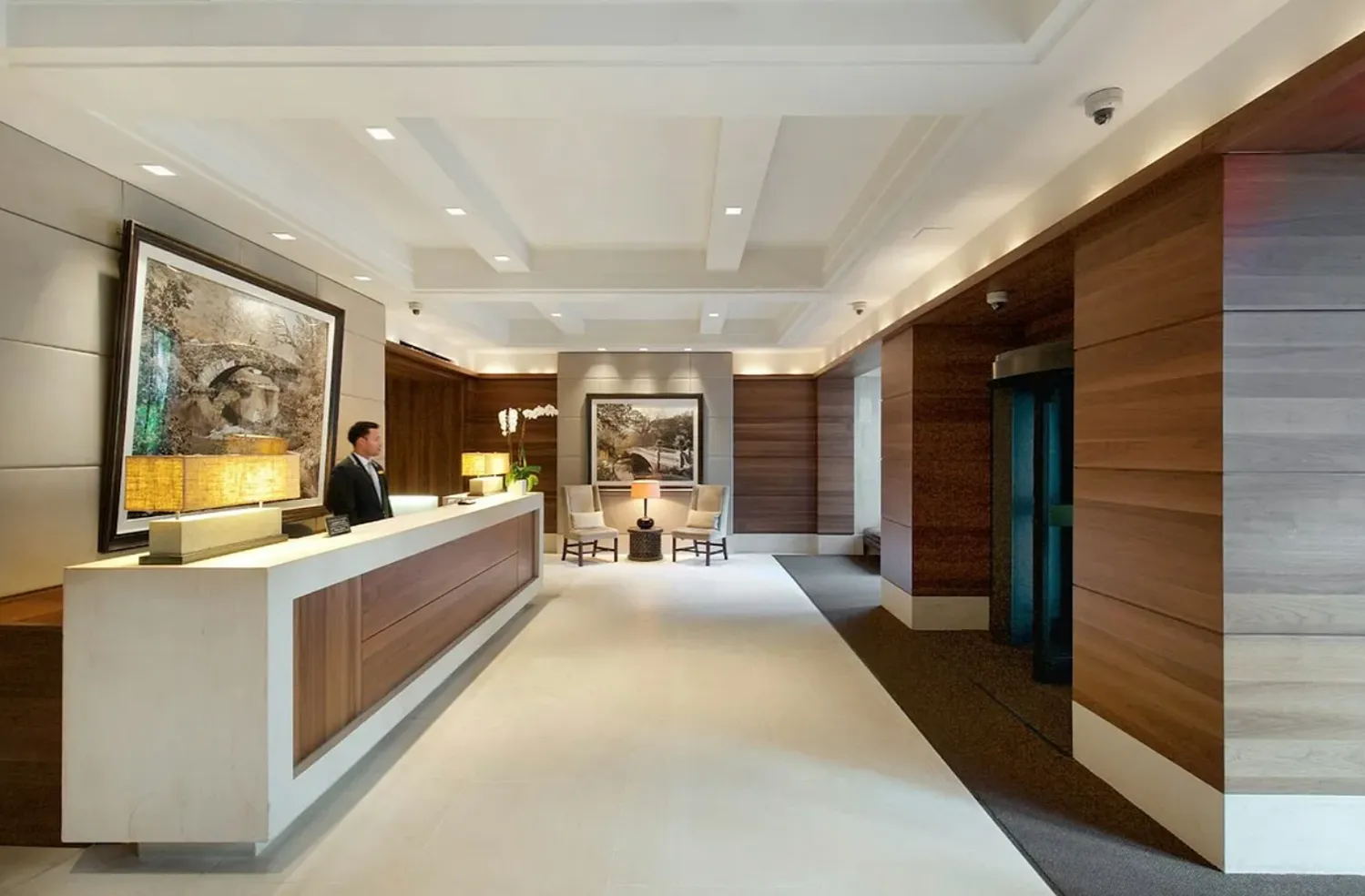 a large living room with stainless steel appliances kitchen island granite countertop a large window and a couch