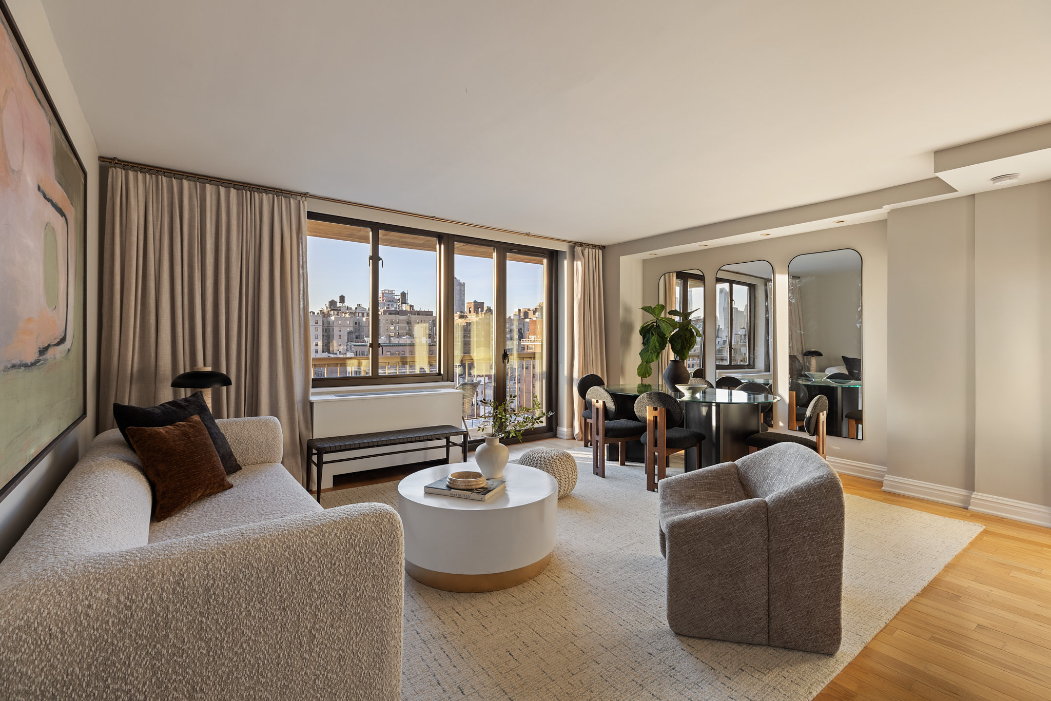 a living room with furniture and floor to ceiling window