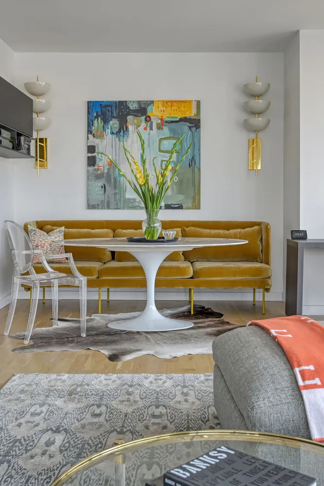 a living room with a couch and painting on the wall