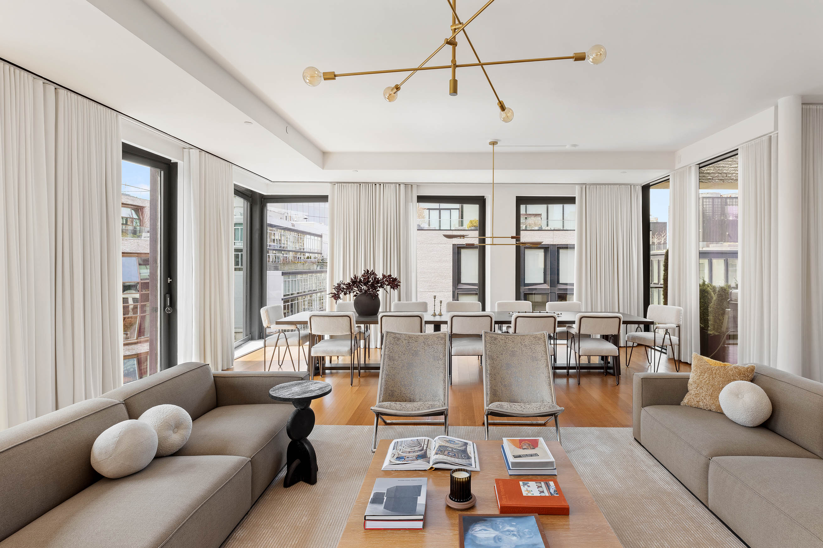 505 West 19th Street, Unit PH1 Manhattan, NY 10011 - Photo 3 of 26 a living room with furniture and floor to ceiling windows