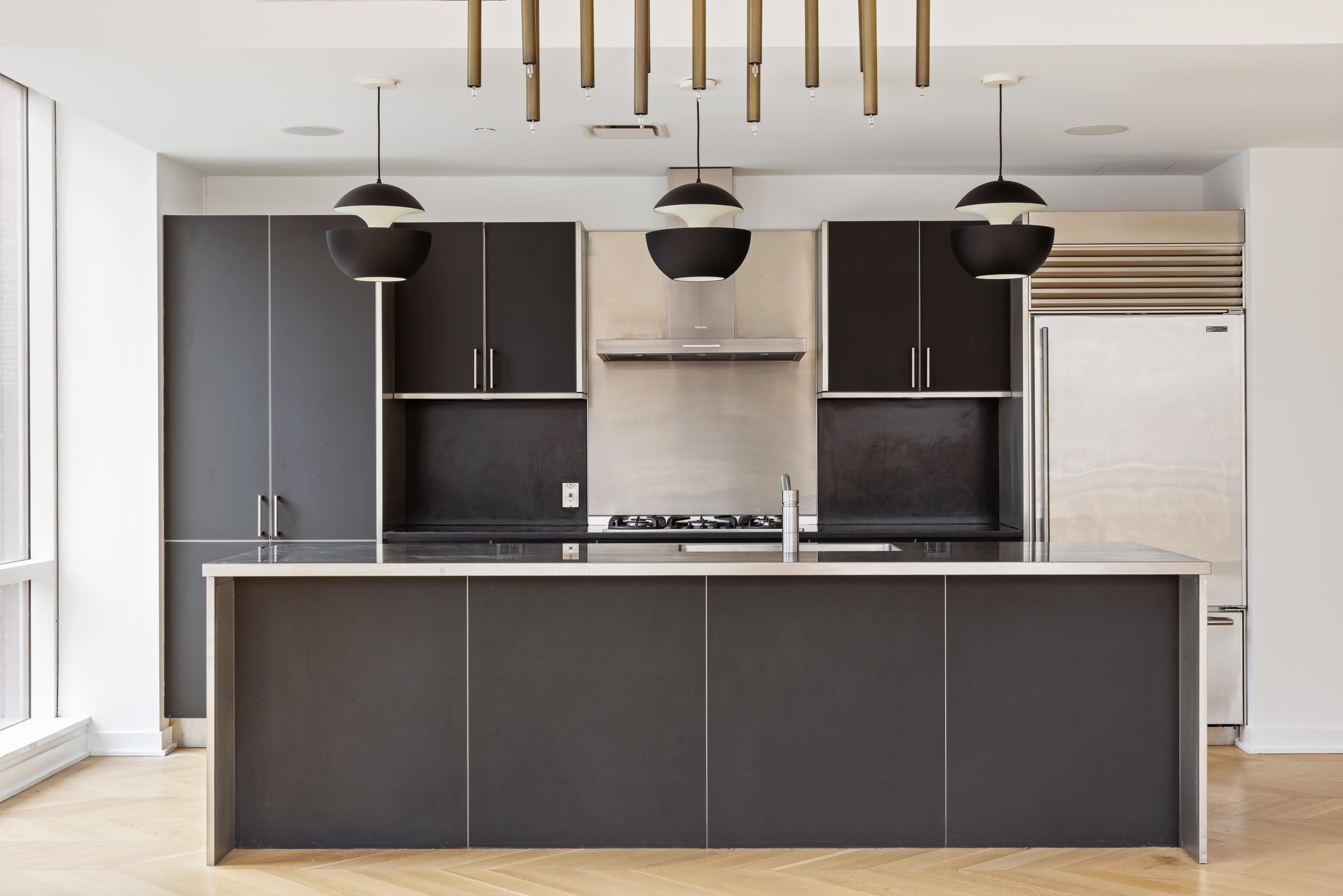 330 Spring Street, Unit 6A Manhattan, NY 10013 - Photo 4 of 11 a kitchen with a refrigerator and cabinets