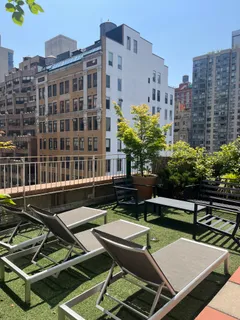 a view of a building with a backyard and sitting area