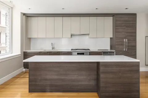 a kitchen with granite countertop a sink and a stove