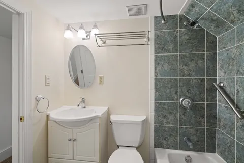 a bathroom with a sink toilet and a mirror