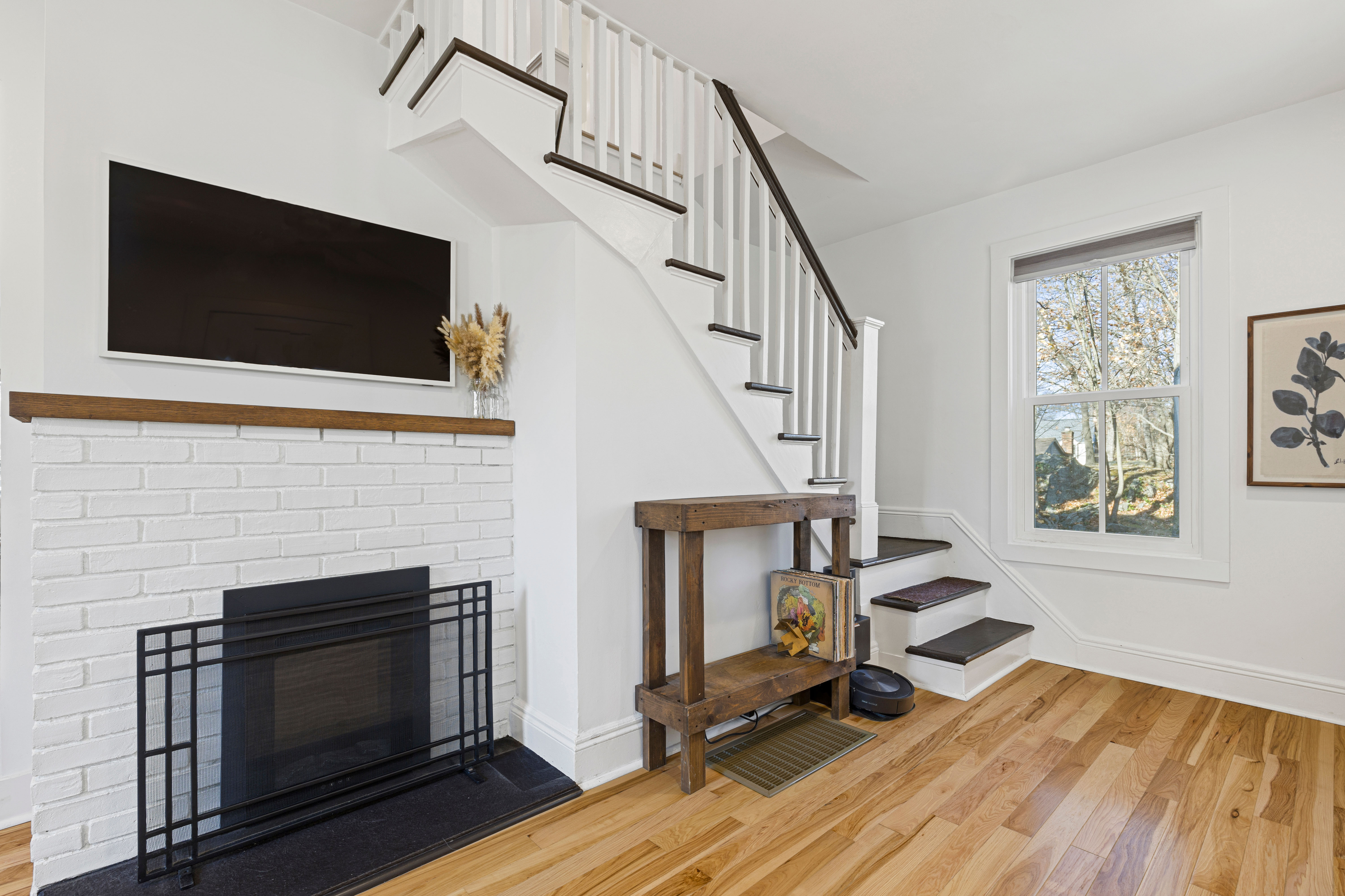 467 Midland Avenue Rye, NY 10580 - Photo 3 of 19 a living room with furniture a flat screen tv and a fireplace