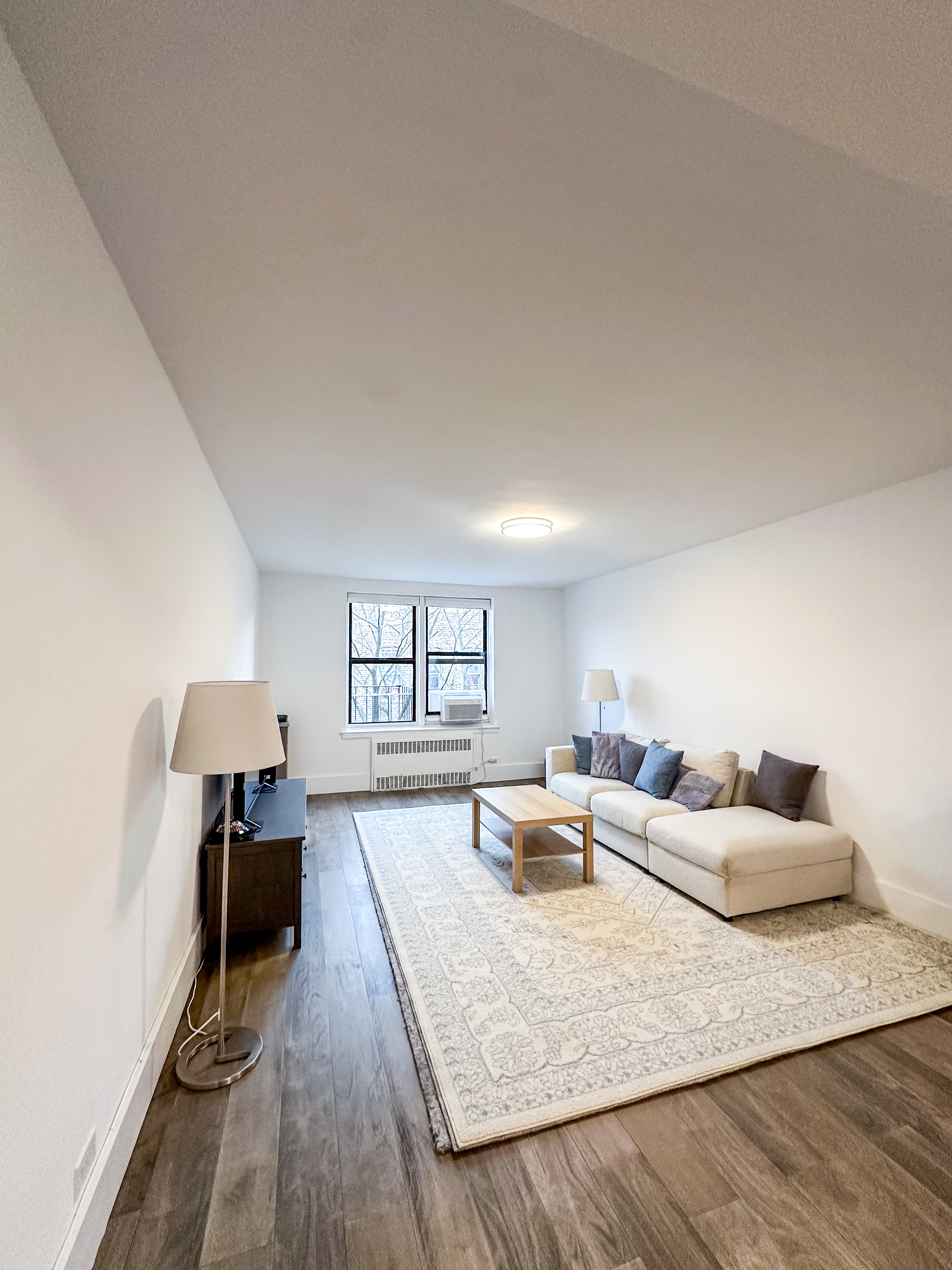 2420 Morris Avenue, Unit 6B Bronx, NY 10468 - Photo 2 of 16 a living room with furniture and a wooden floor