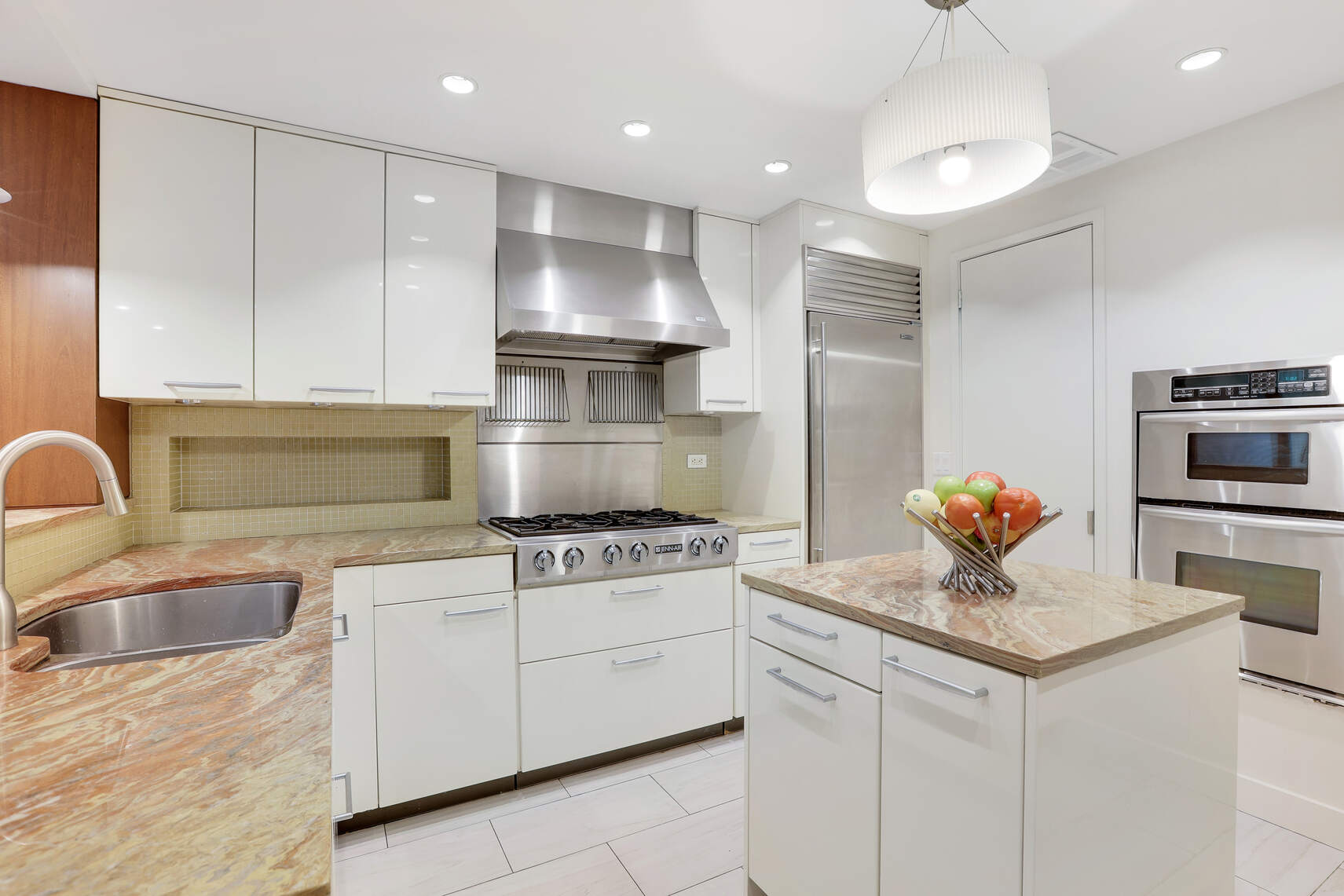 344 West 23rd Street, Unit 1E Manhattan, NY 10011 - Photo 15 of 19 a kitchen with granite countertop a stove sink and refrigerator
