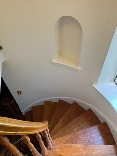 a view of an empty room with a fireplace and a window