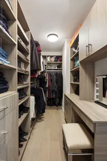 a view of walk in closet with clothes and shoes