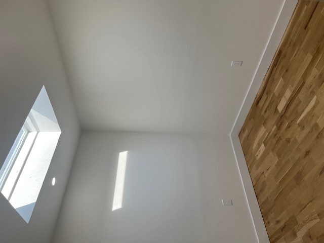 1393 Herkimer Street, Unit 2 Brooklyn, NY 11233 - Photo 7 of 9 a view of an empty room with wooden floor and a window