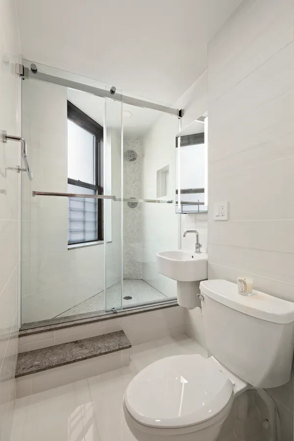 a bathroom with a toilet sink and shower