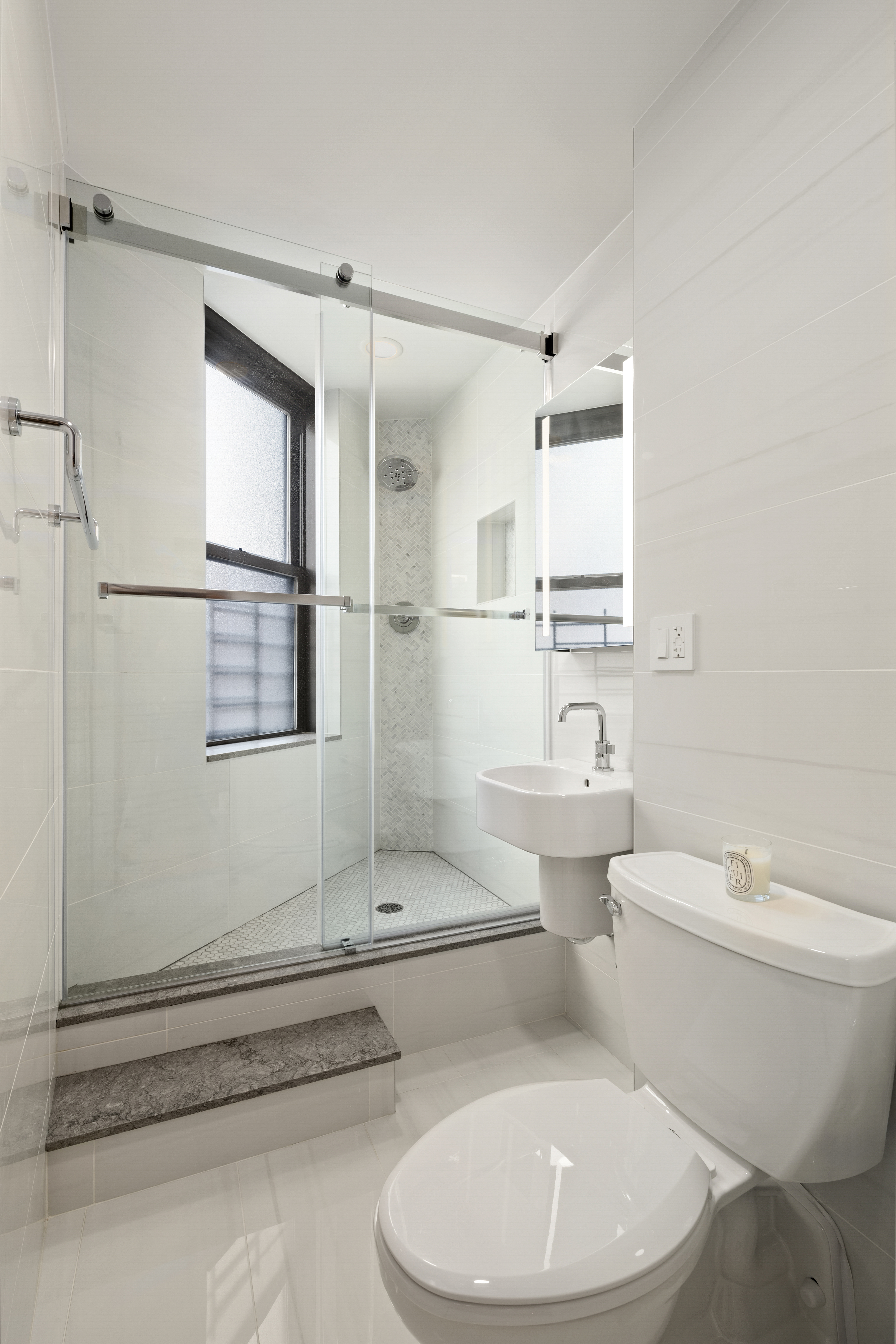 340 West 55th Street, Unit 5C Manhattan, NY 10019 - Photo 6 of 10 a bathroom with a toilet sink and shower