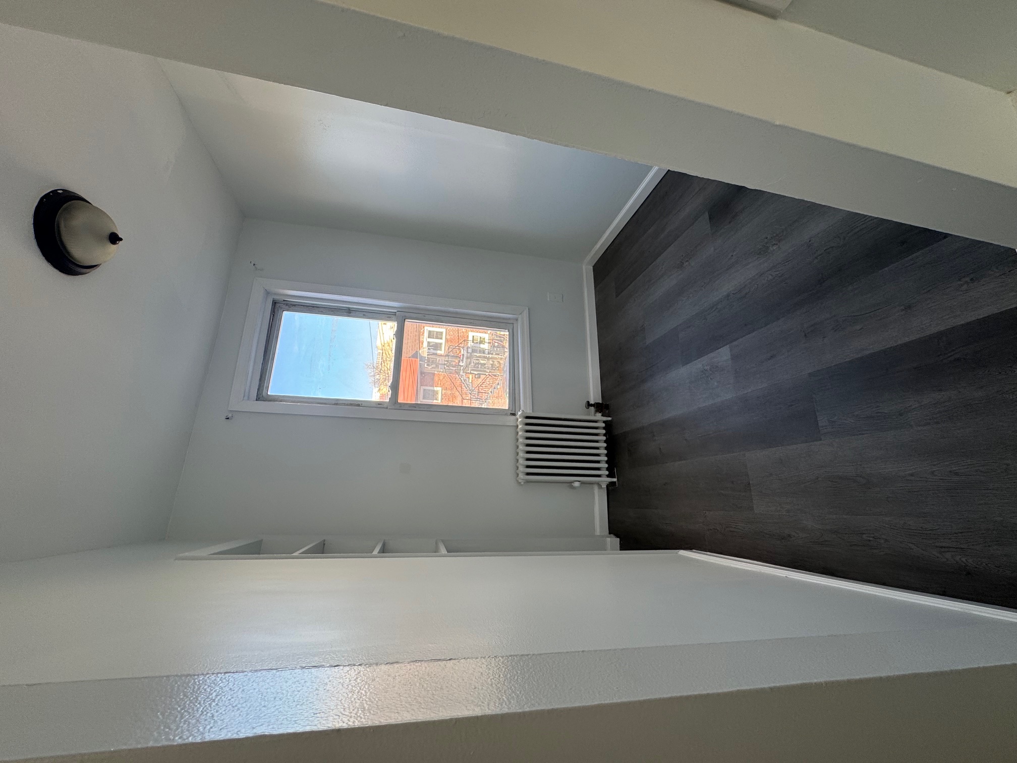 89-16 102nd Road, Unit 2 Queens, NY 11416 - Photo 11 of 13 an empty room with wooden floor and windows