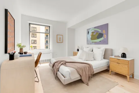 a bedroom with a bed and glass windows
