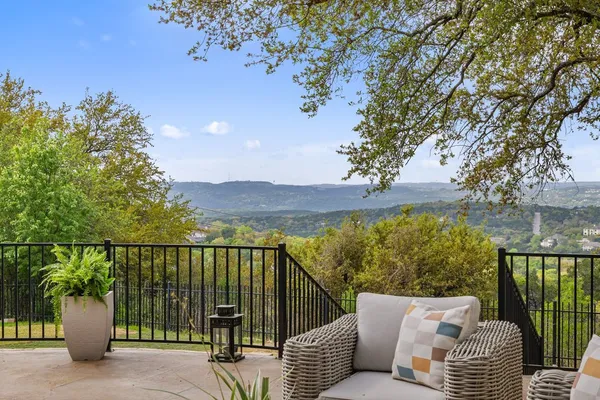 a view of a balcony with two chairs