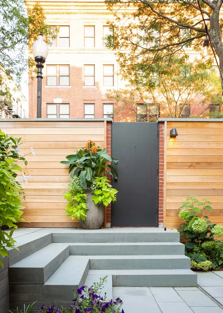 a front view of a house with plants