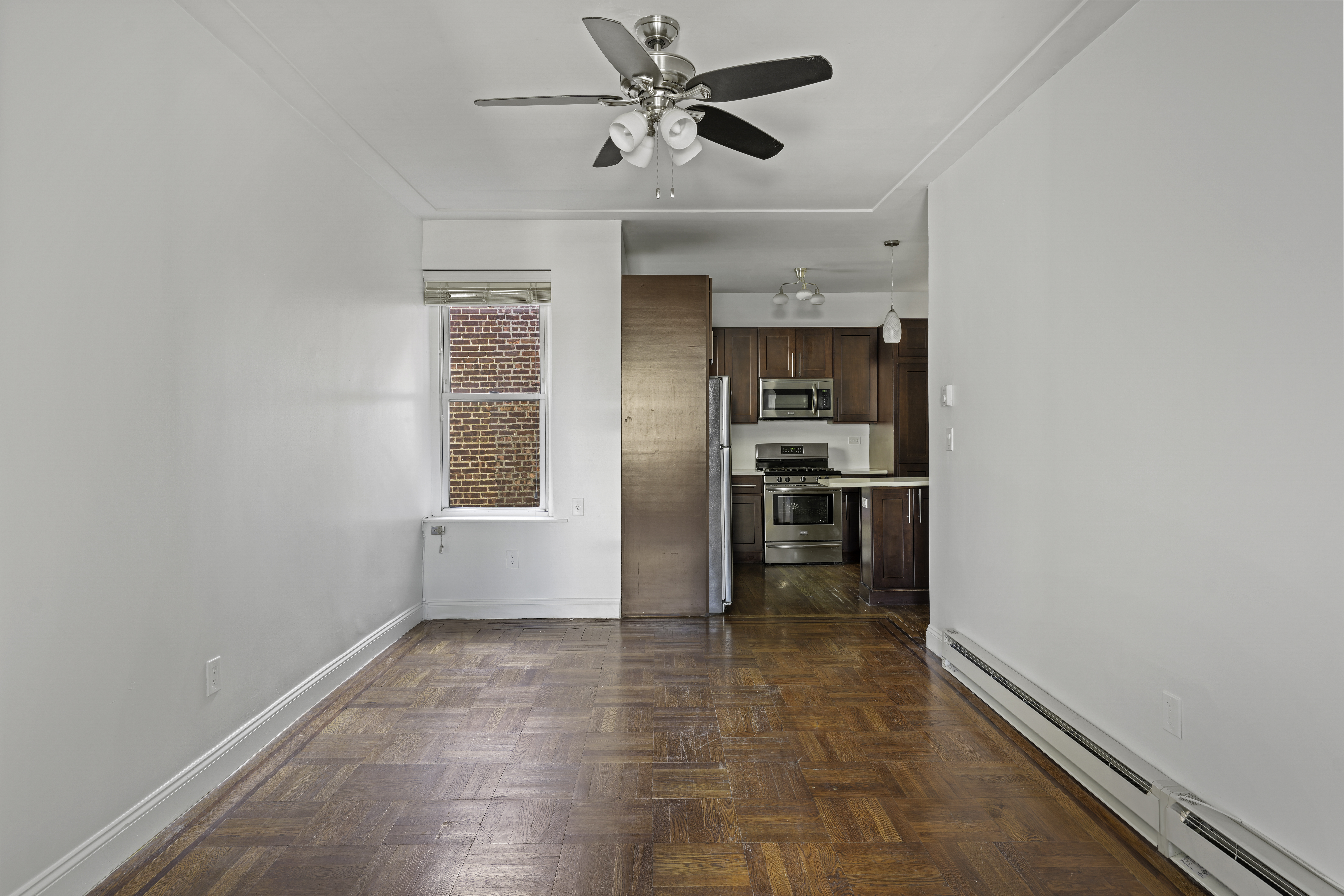 514 86th Street, Unit 4 Brooklyn, NY 11209 - Photo 9 of 19 a view of a kitchen with wooden cabinet and a ceiling fan