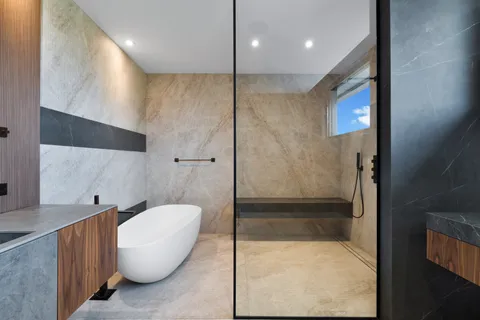 a bathroom with a bathtub and a shower