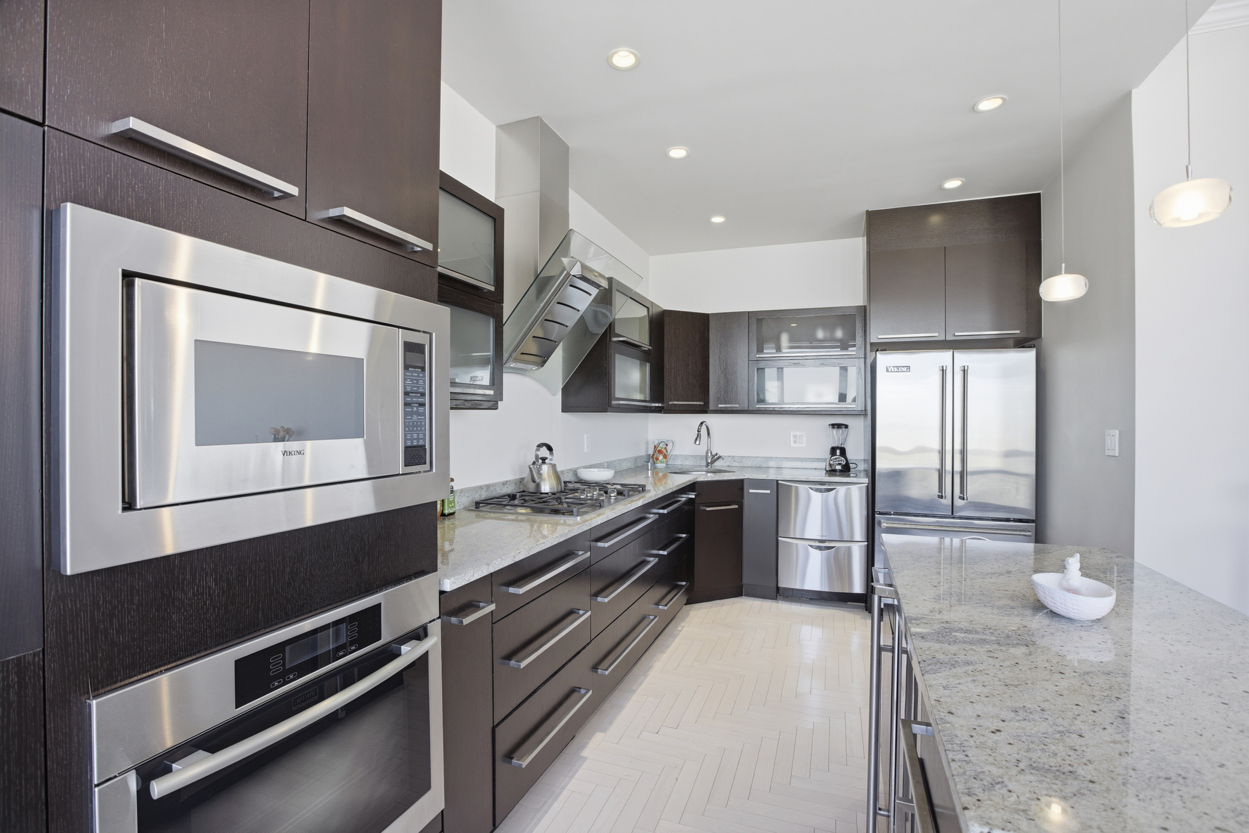 418 East 59th Street, Unit PHA Manhattan, NY 10022 - Photo 5 of 17 a kitchen with a sink stainless steel appliances and cabinets