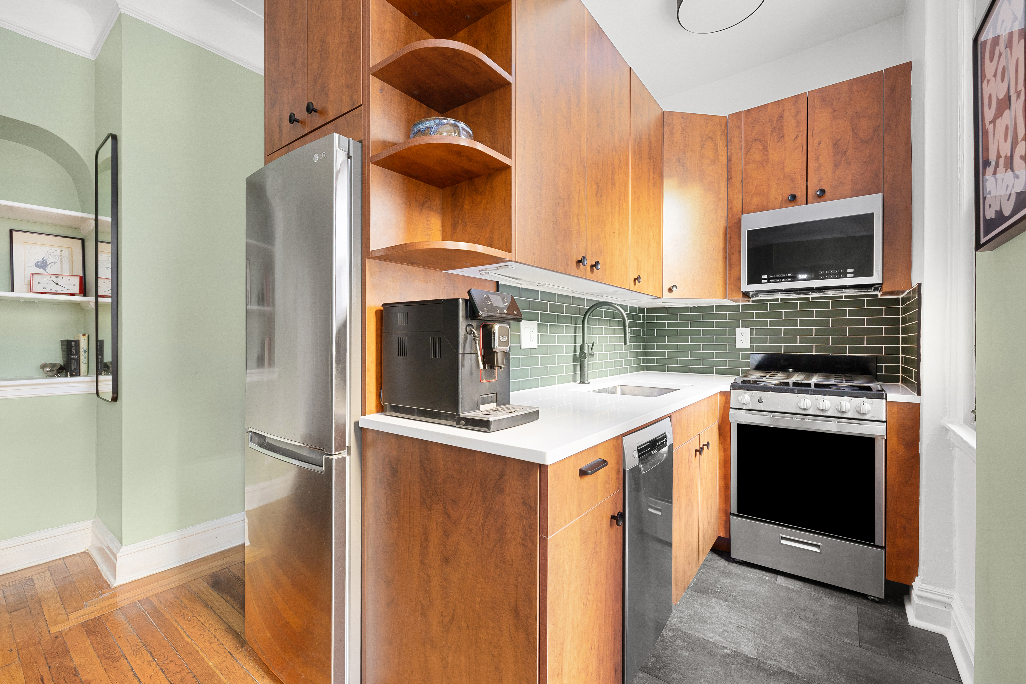 78 8th Avenue, Unit 2K Brooklyn, NY 11215 - Photo 4 of 10 a kitchen with stainless steel appliances granite countertop a stove and a refrigerator