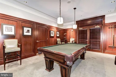 a view of a patio with couches table and chairs and potted plants