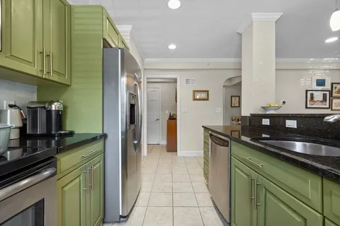a kitchen with stainless steel appliances granite countertop a sink and cabinets