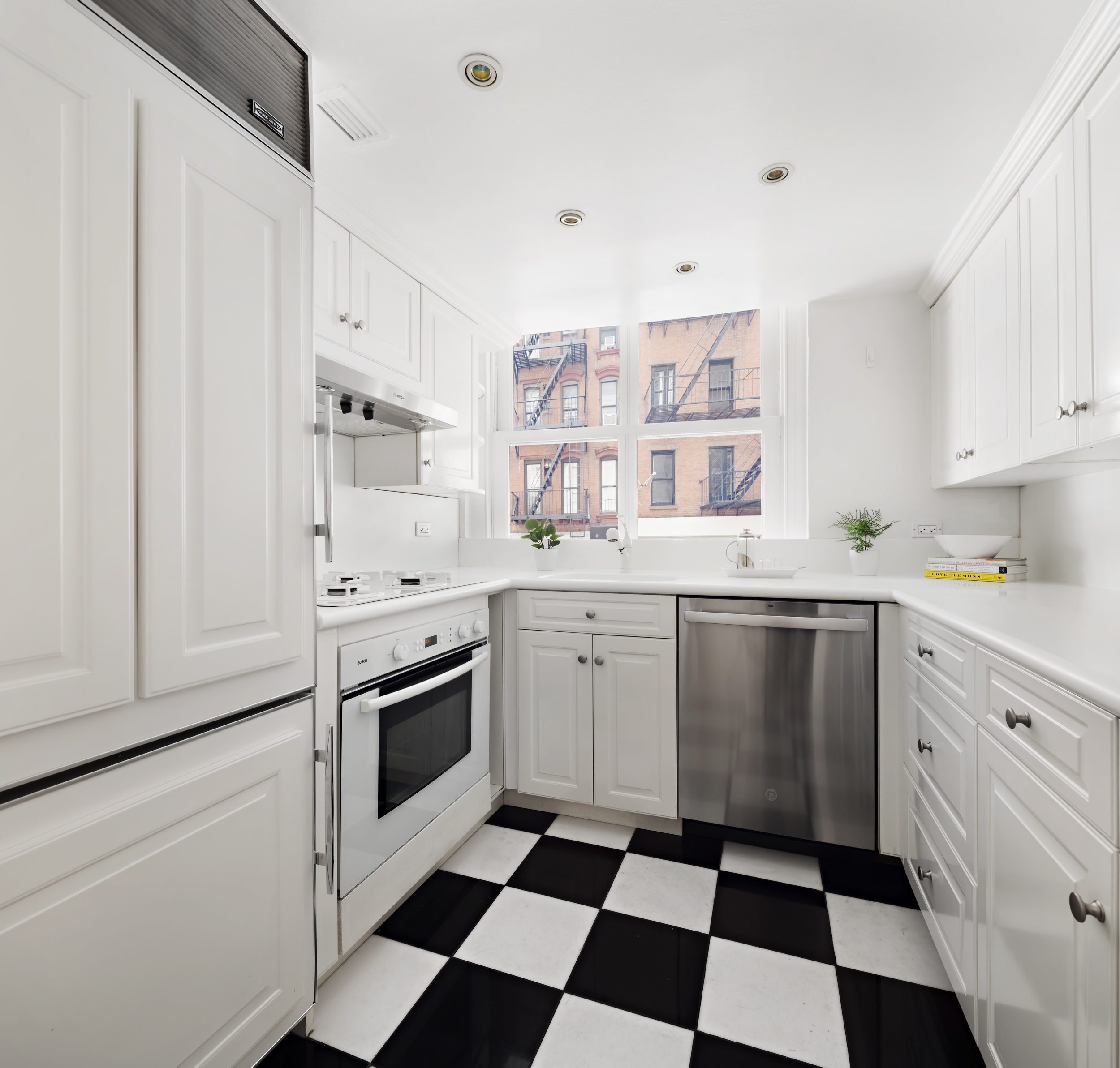 240 Centre Street, Unit 2J Manhattan, NY 10013 - Photo 11 of 18 a kitchen with stainless steel appliances a stove a sink and a refrigerator