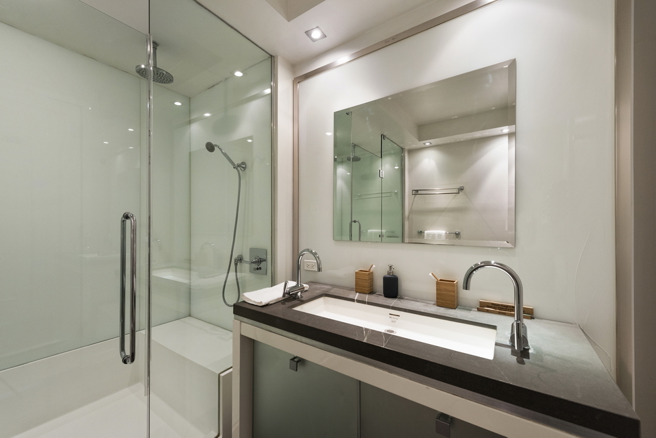 444 West 19th Street, Unit 201 Manhattan, NY 10011 - Photo 8 of 13 a bathroom with a granite countertop sink and a mirror