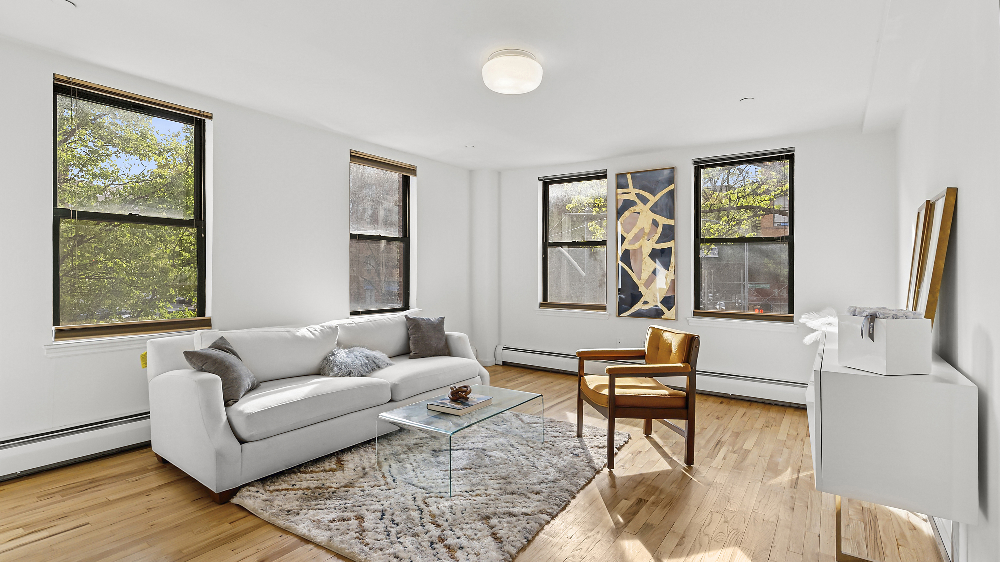 2792 Frederick Douglass Boulevard, Unit 2B Manhattan, NY 10039 - Photo 1 of 11 a living room with furniture and a window