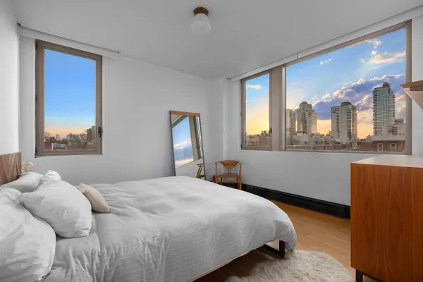a bedroom with a large bed and a window