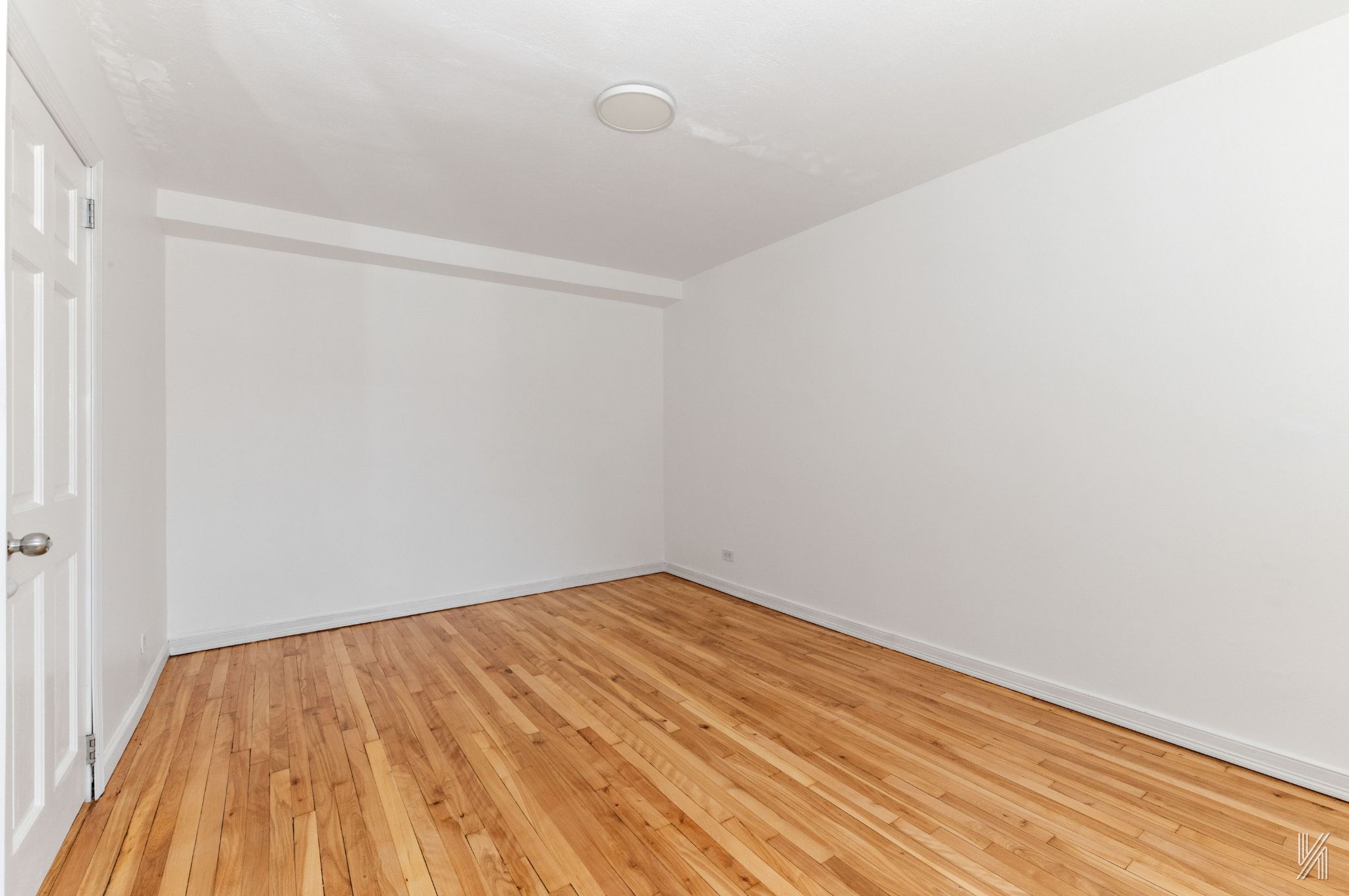87-10 34th Avenue, Unit 1F Queens, NY 11372 - Photo 13 of 16 a view of empty room with wooden floor
