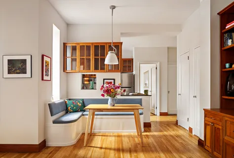 a living room with furniture a rug and white walls