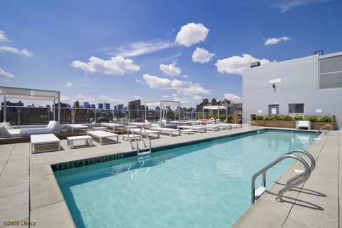 a view of a swimming pool and lounge chairs