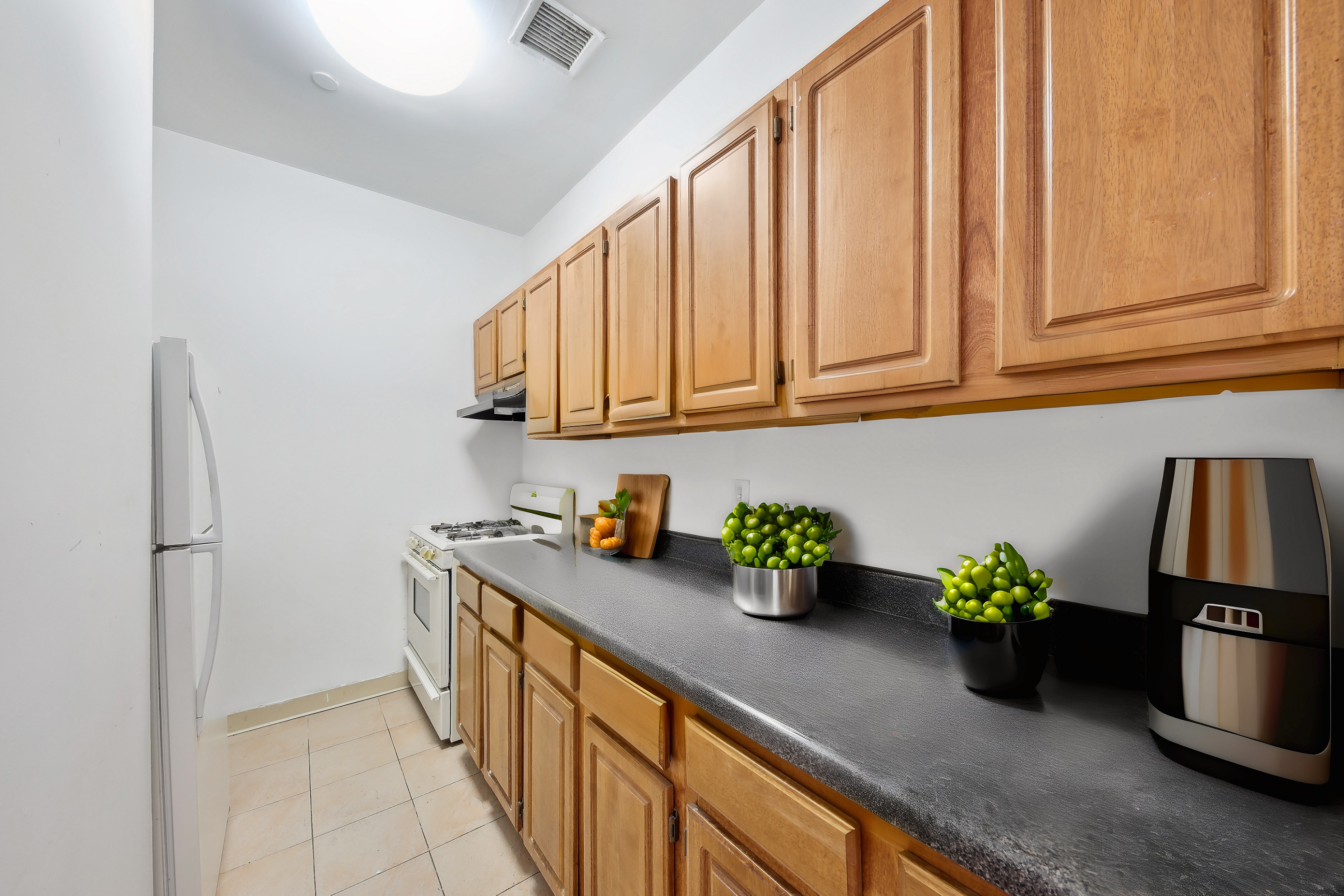 482 West 150th Street, Unit 2D Manhattan, NY 10031 - Photo 2 of 4 a kitchen with stainless steel appliances granite countertop a sink a refrigerator and a cabinets