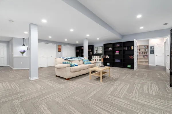 a spacious bedroom with a bed and a cabinets