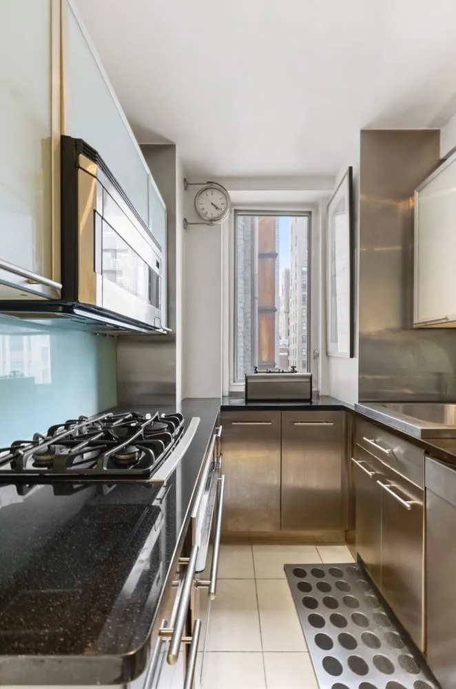 a kitchen with a stove a sink and a microwave