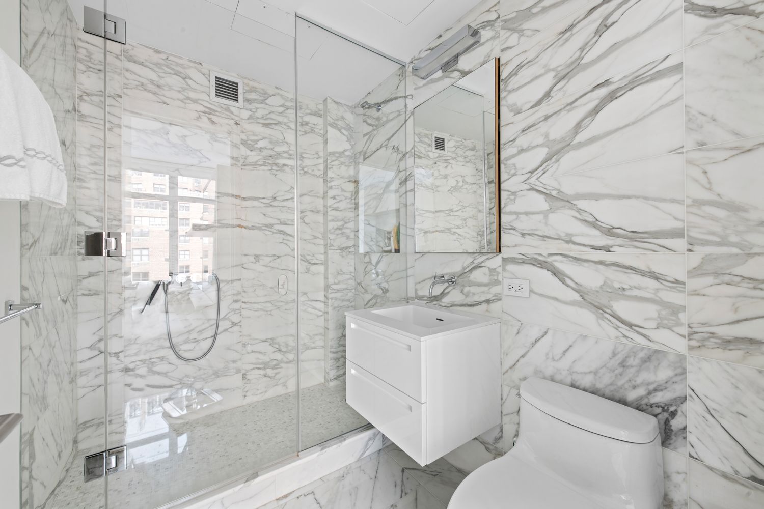 207 East 57th Street, Unit 12A Manhattan, NY 10022 - Photo 10 of 13 a bathroom with a shower toilet and sink