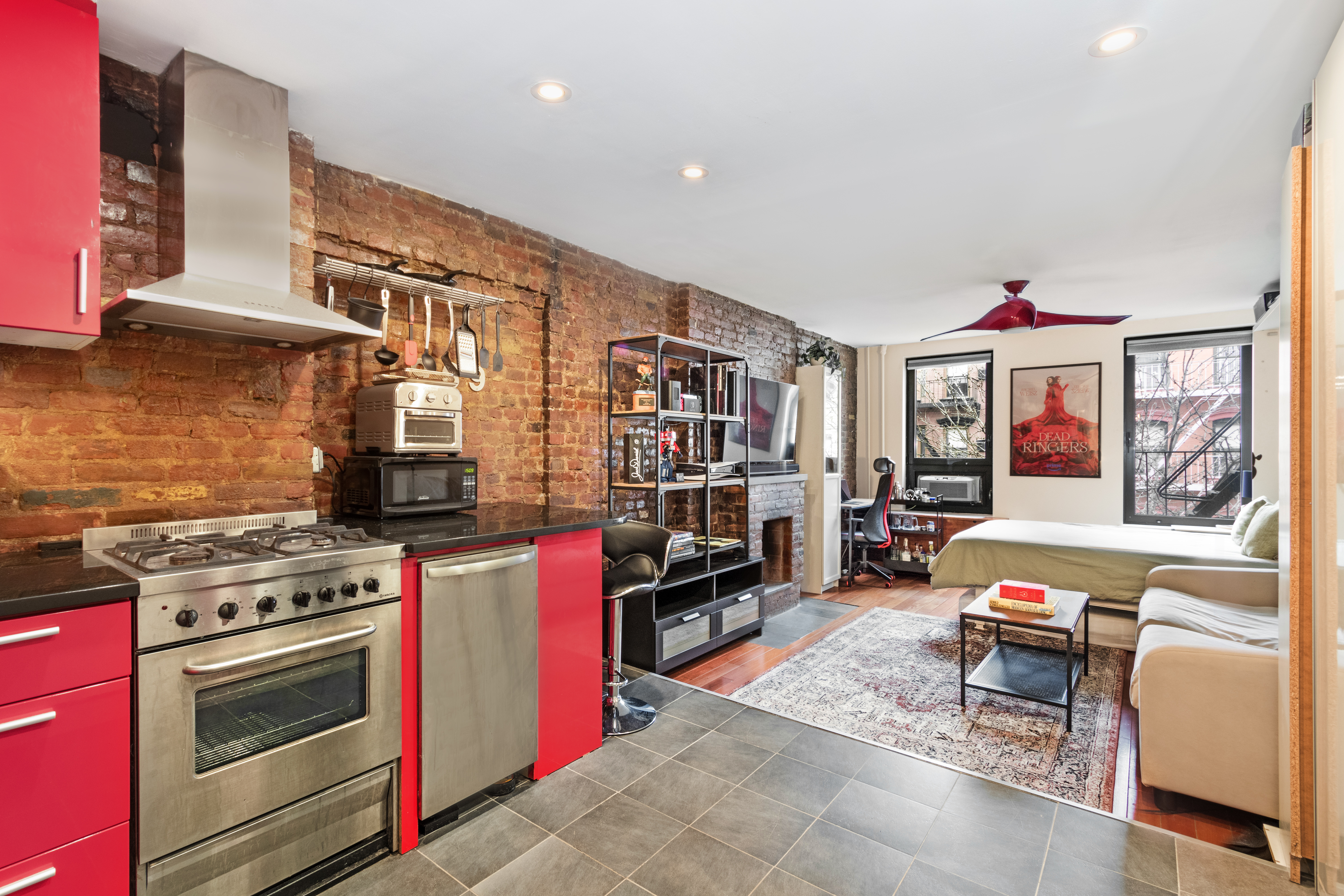88 East 3rd Street, Unit 15 Manhattan, NY 10003 - Photo 2 of 6 a living room with furniture and a fireplace
