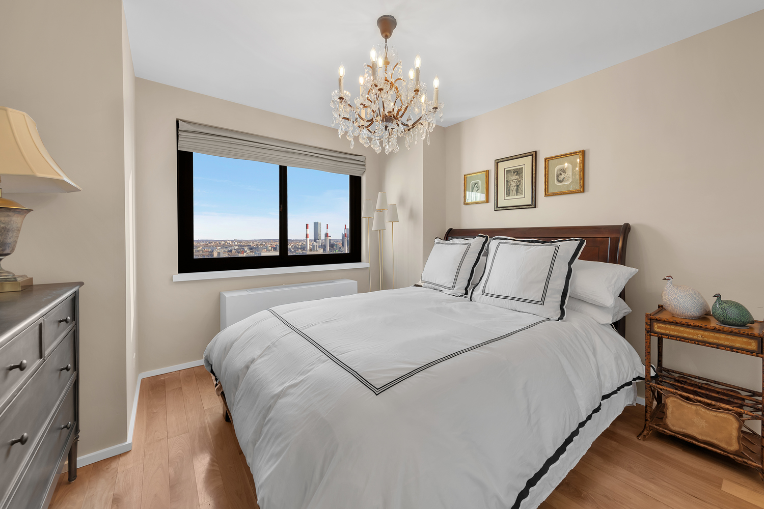 515 East 72nd Street, Unit 36B Manhattan, NY 10021 - Photo 13 of 36 a bedroom with bed and a chandelier