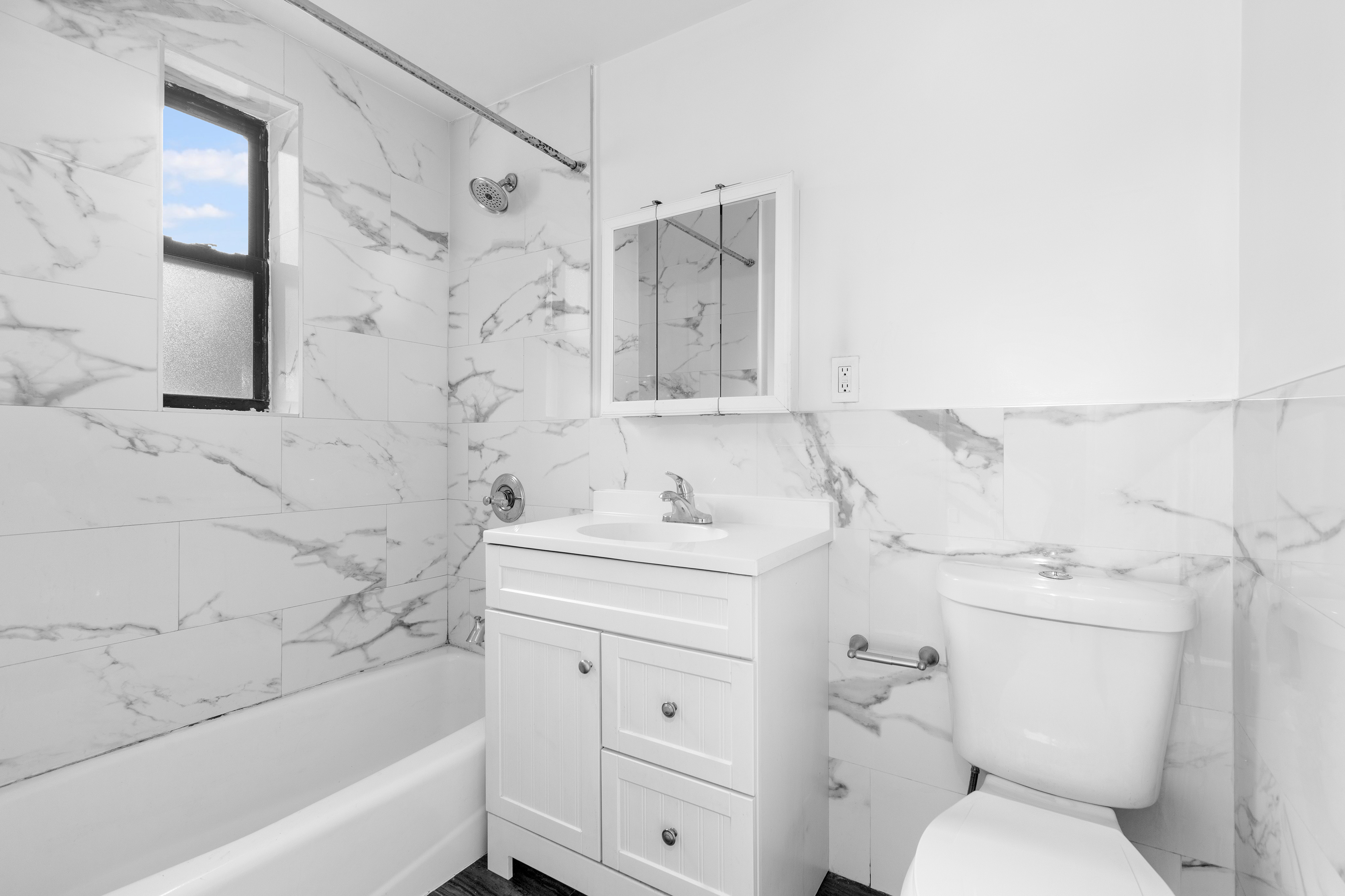 1582 York Avenue, Unit 5B Manhattan, NY 10028 - Photo 6 of 14 a bathroom with a sink toilet vanity and bathtub