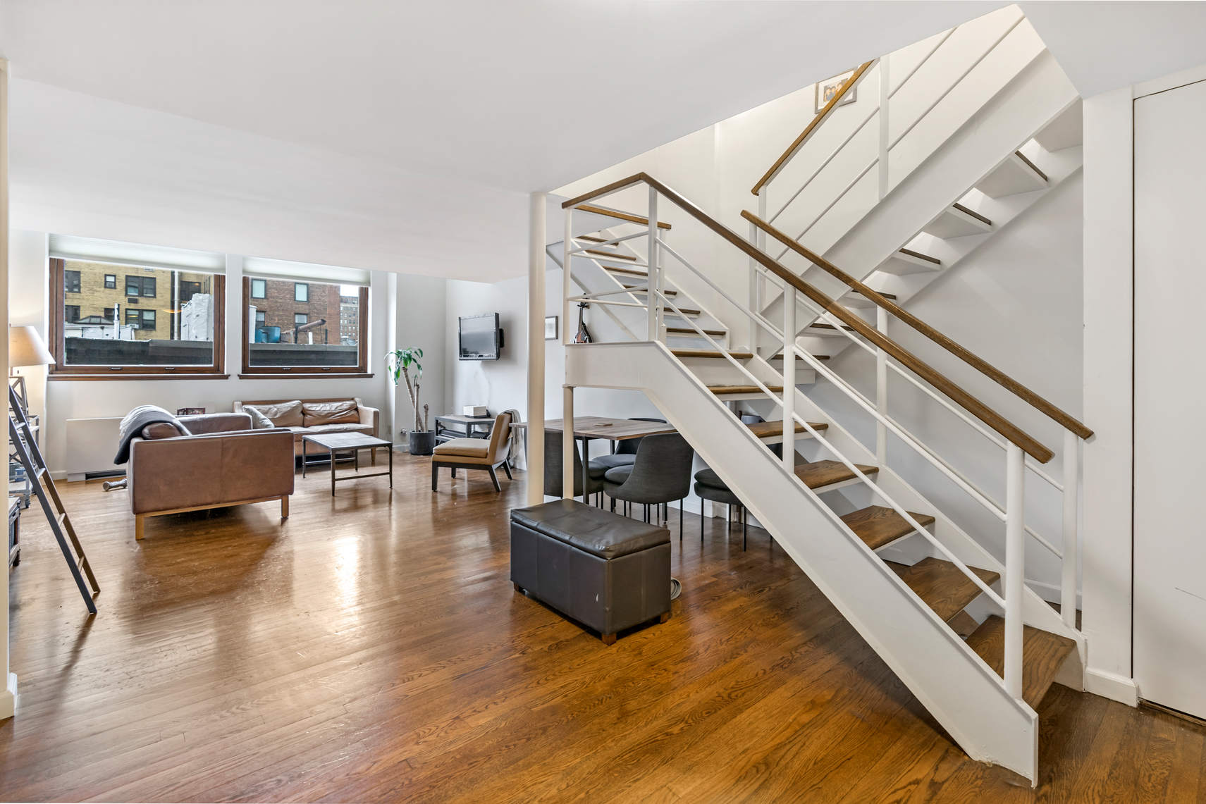 305 2nd Avenue, Unit 518 Manhattan, NY 10003 - Photo 9 of 19 a living room with furniture and a flat screen tv