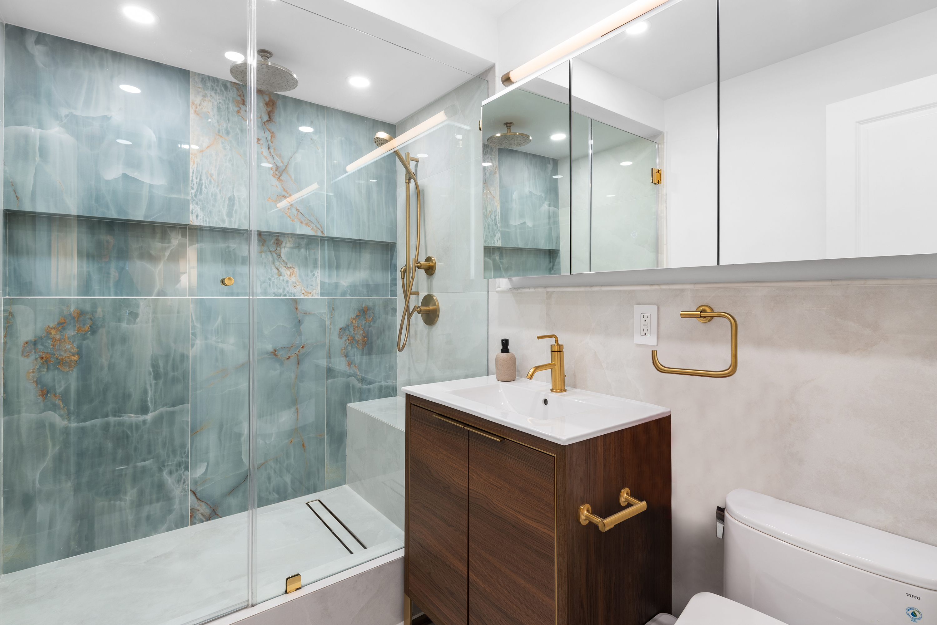 30 East 65th Street, Unit 6B Manhattan, NY 10065 - Photo 10 of 14 a bathroom with a sink a toilet and shower