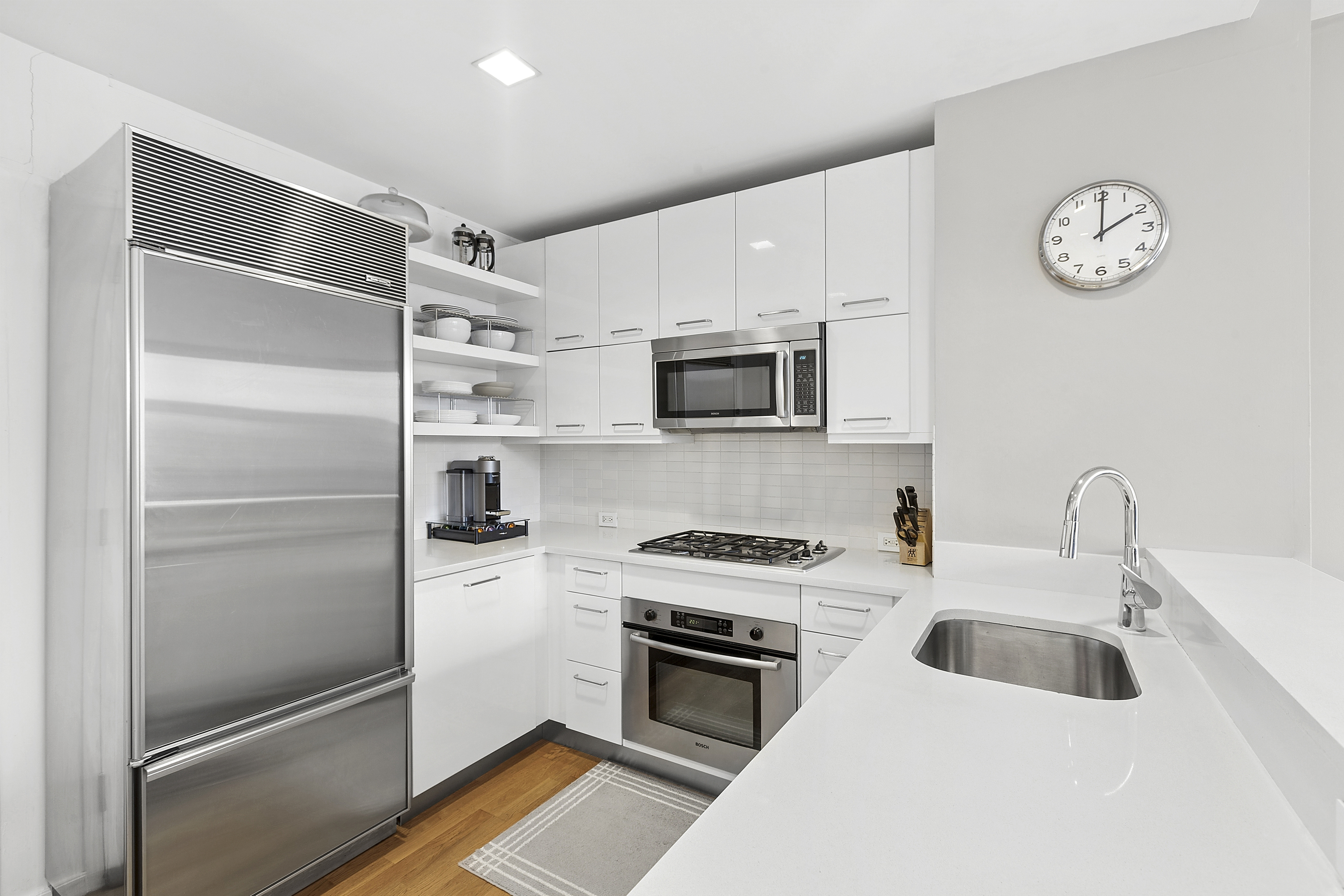 635 West 42nd Street, Unit 4B Manhattan, NY 10036 - Photo 3 of 11 a kitchen with a refrigerator and a sink