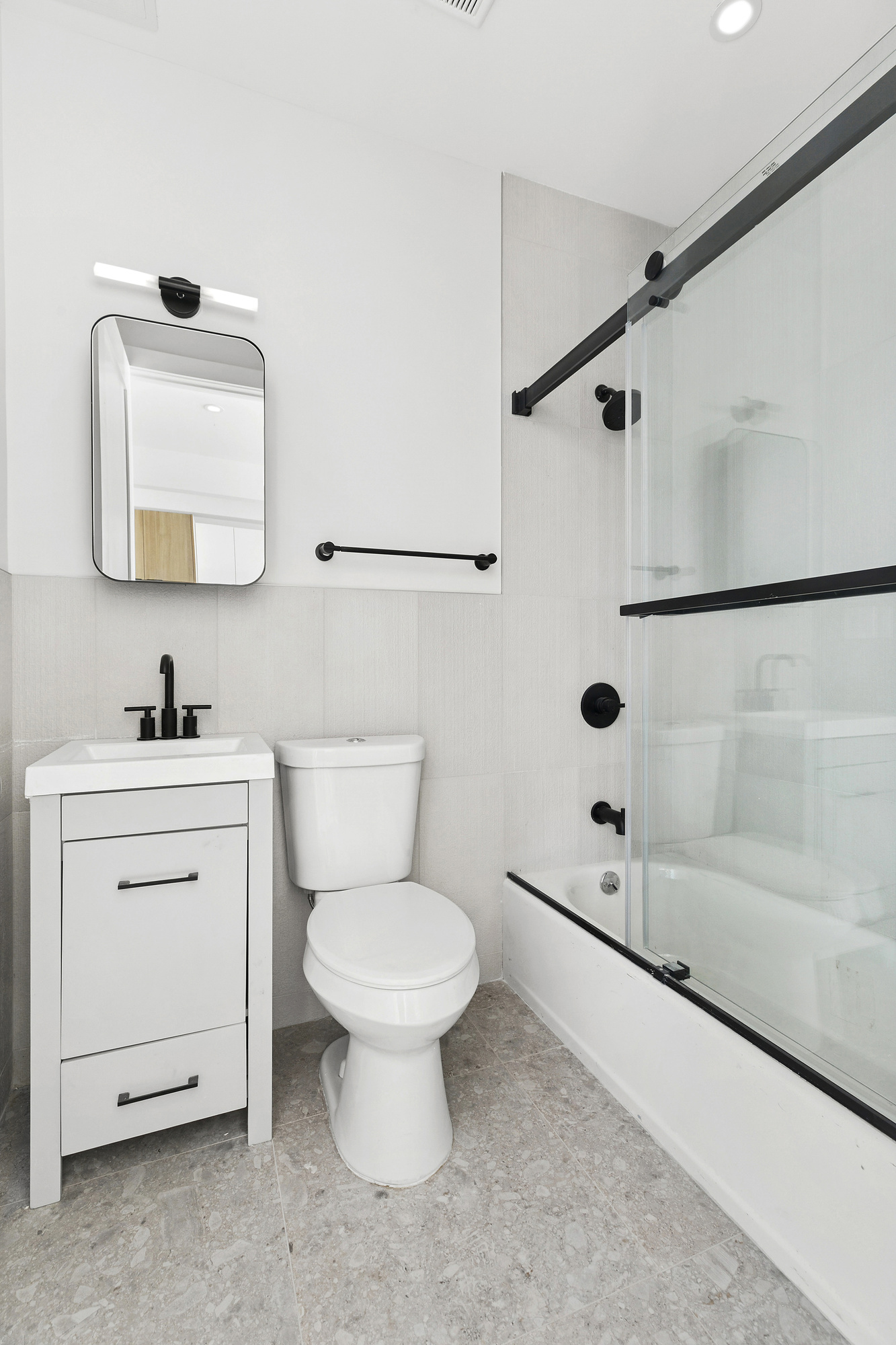 647 Dekalb Avenue, Unit 3B Brooklyn, NY 11216 - Photo 5 of 5 a bathroom with a toilet sink and a mirror