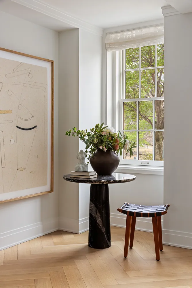 a view of a room with a window and furniture